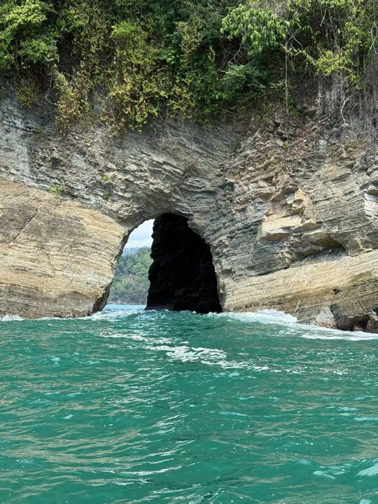 Turquoise water at the entrance to a coastal sea cave