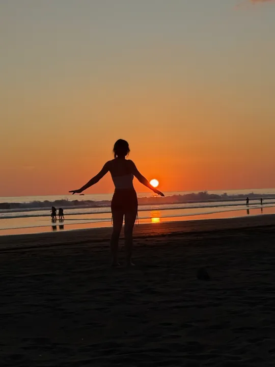 Silhouette of a person on the beach at sunset