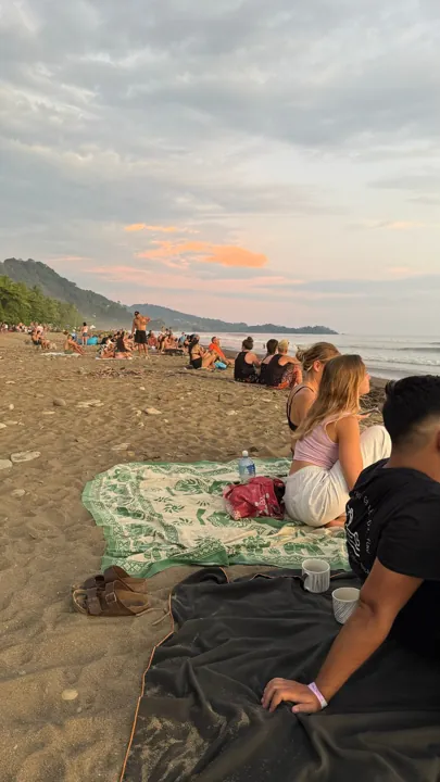 People relaxing on the beach in the evening