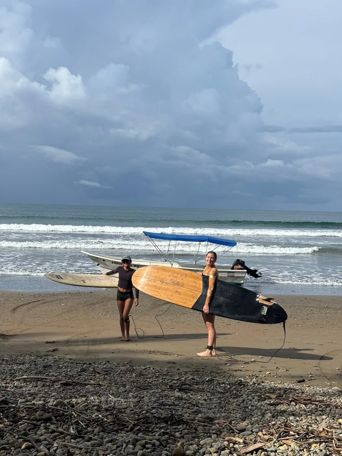 Carrying a board across the beach