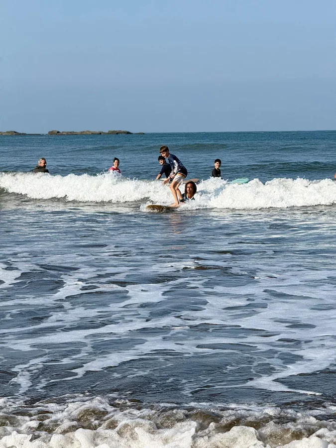 A surfer standing up in the whitewater