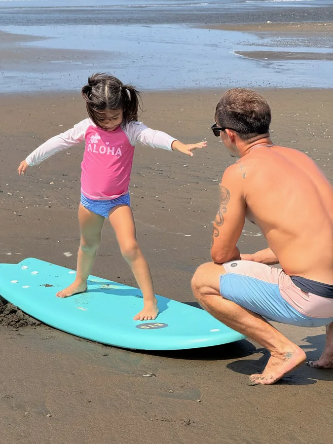 Learning balance with a coach on the beach